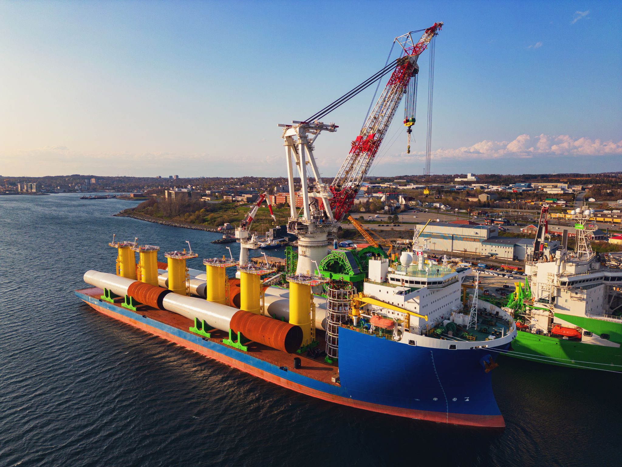 Large ship with cranes at industrial port.
